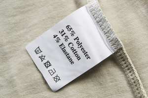 A clothing label listing 65% polyester plastic