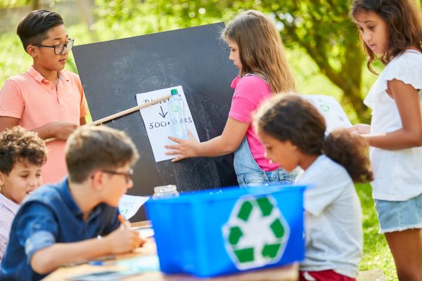 Kids help each other learn in a recycling club