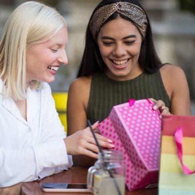 a women giving a friend a gift